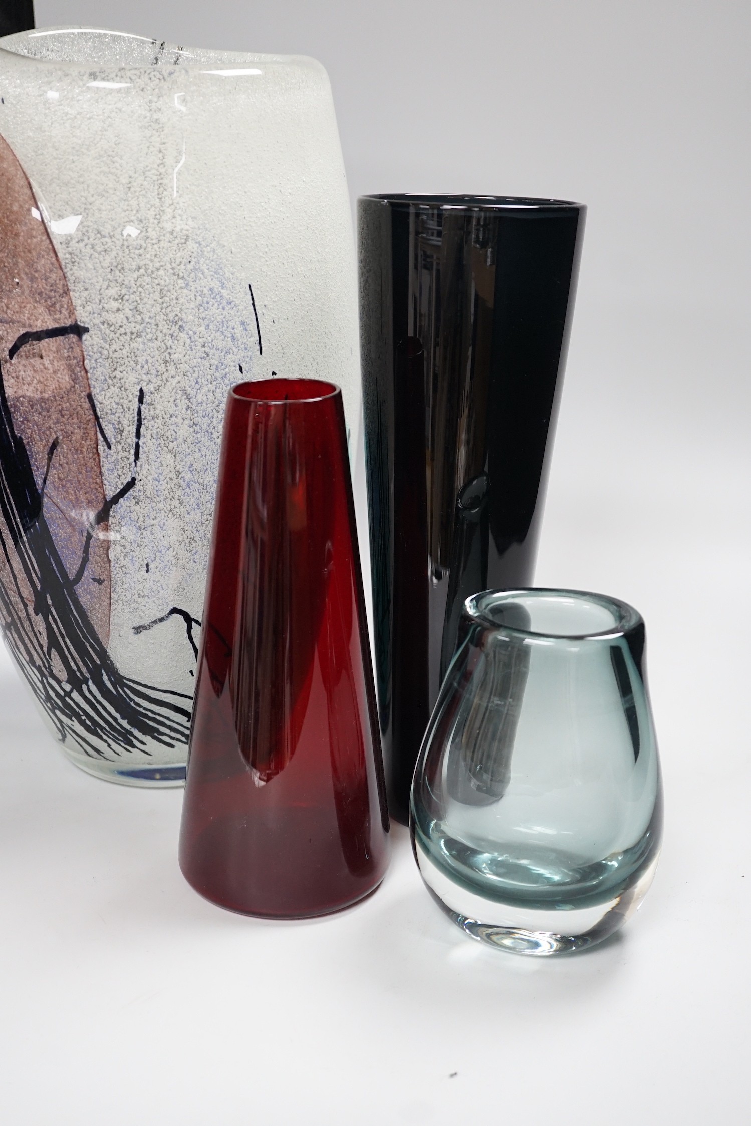 Four studio glass vases, to include Kaj Franck (1911-1989), for Nuutajärvi Notsj, a mid century blue conical glass vase an interesting multi coloured abstract bubble suffused vase- 36cms high